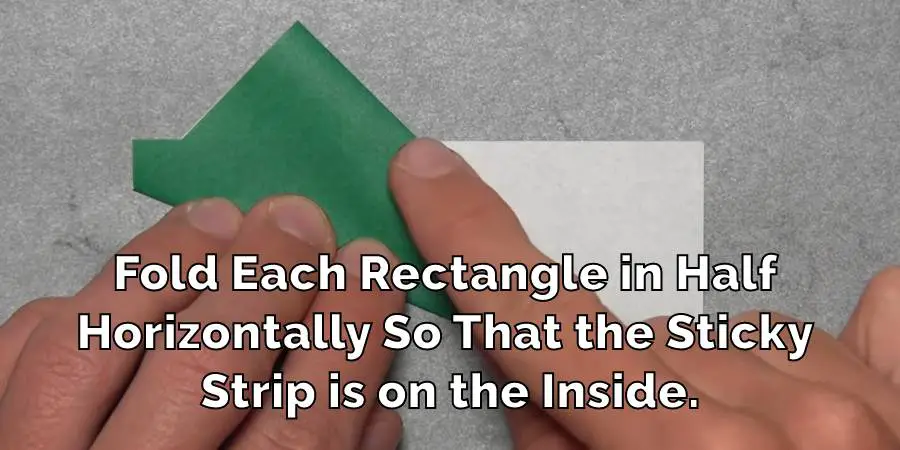 Fold Each Rectangle in Half Horizontally So That the Sticky Strip is on the Inside.